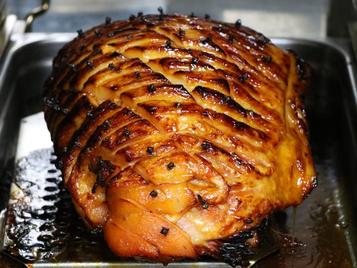 Image: A Leg of Ham scored and glazed, cooking away in the oven looking delicious.